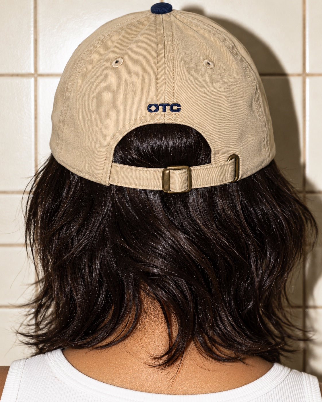 A/C Tourist Cap in Navy/Khaki worn by a model, back view, with a small navy OTC above the strap