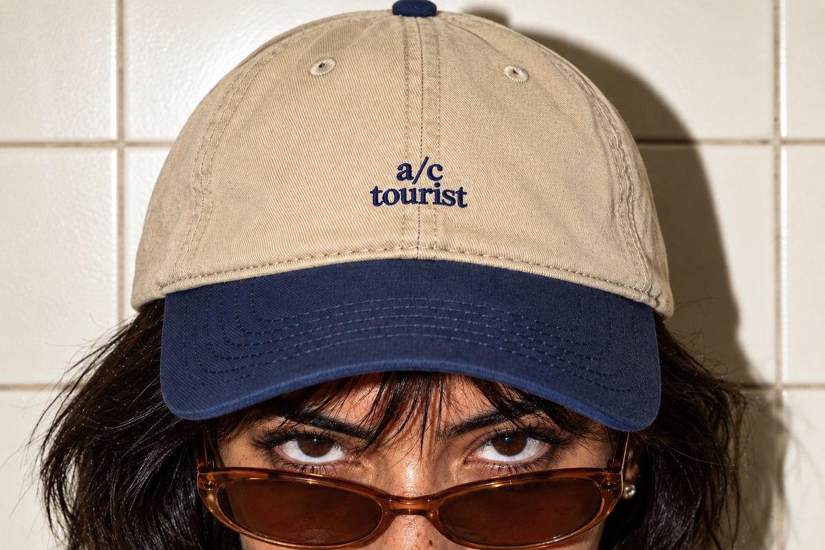 Detail of the navy “a/c tourist” embroidery on the khaki crown of the A/C Tourist Cap