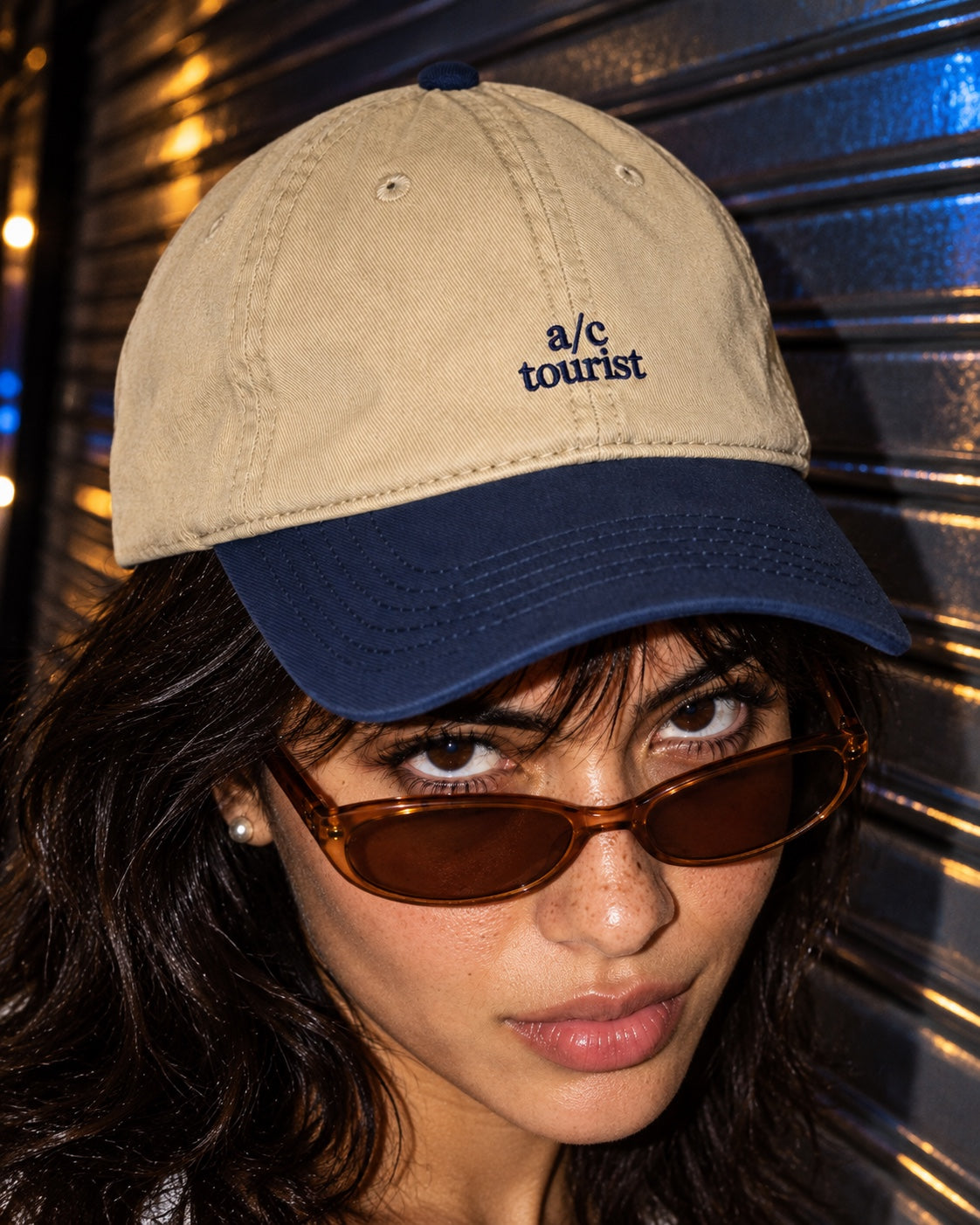 A/C Tourist Cap in Navy/Khaki worn by a model on a street at night, front view