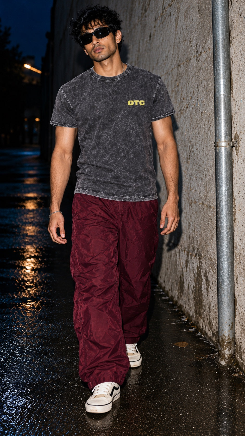 Air Time Tee in washed black denim worn by a model, front view, in an alley at night