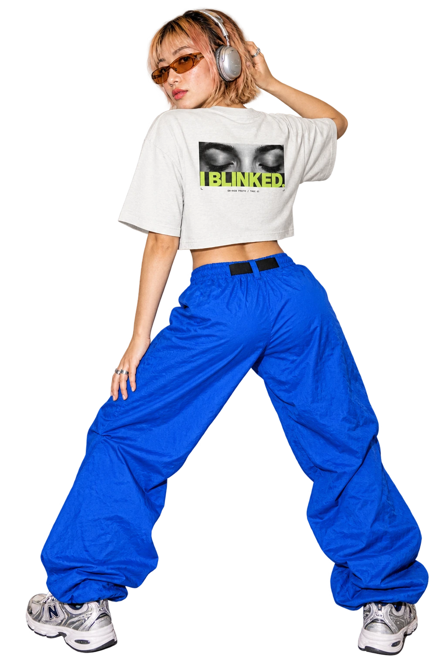 I BLINKED cropped tee worn by a model, back view, studio