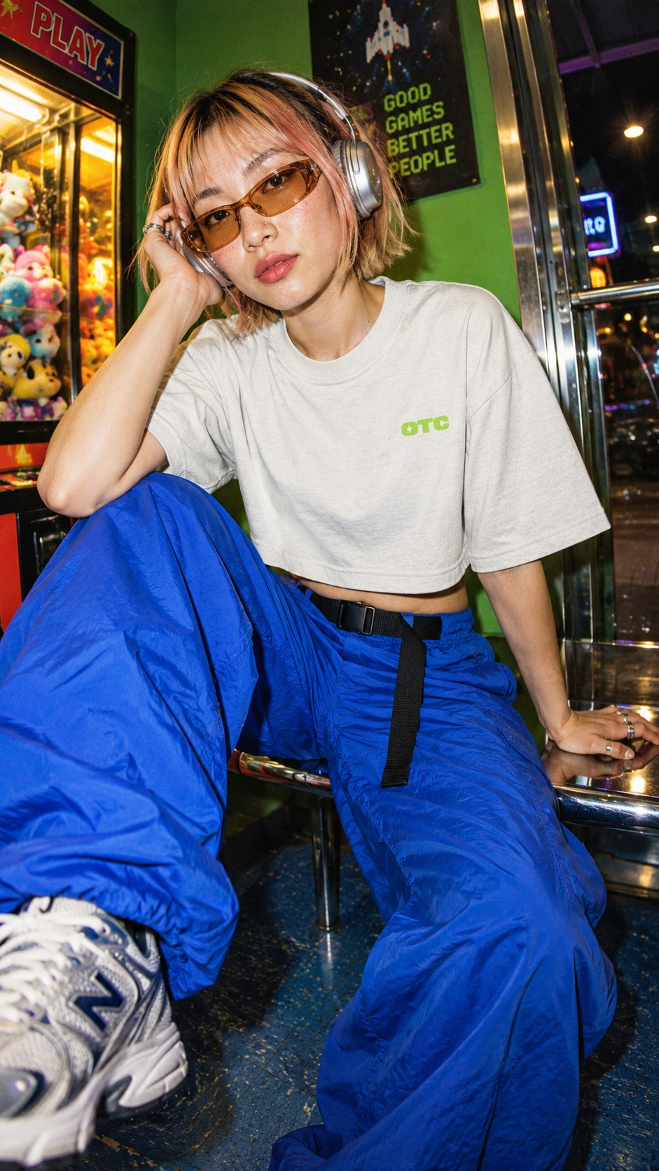 I BLINKED cropped tee worn by a model, front view, at the arcade claw machines