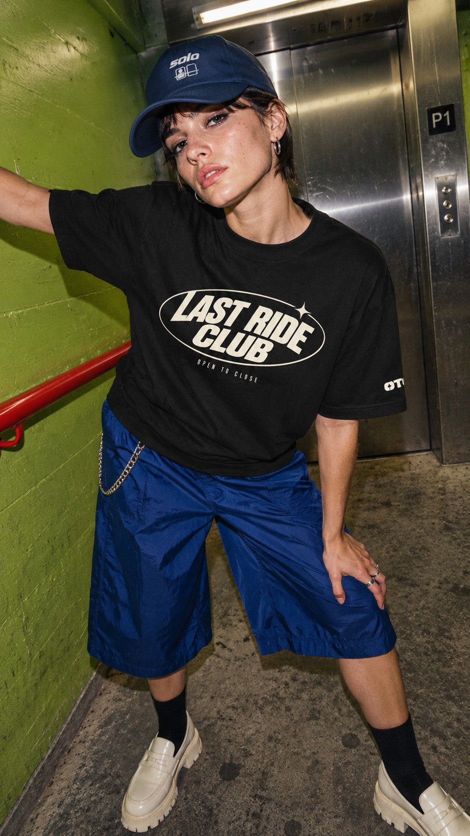 Last Ride Club Boxy Tee worn by a model, front view, in a lift lobby