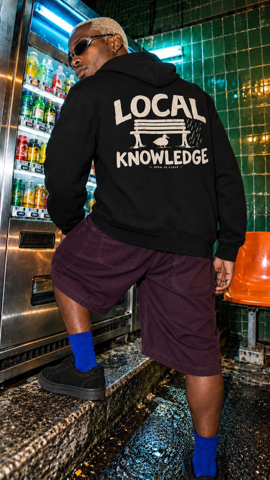 Local Knowledge Side Pocket Hoodie worn by a model, back view, by a drinks fridge