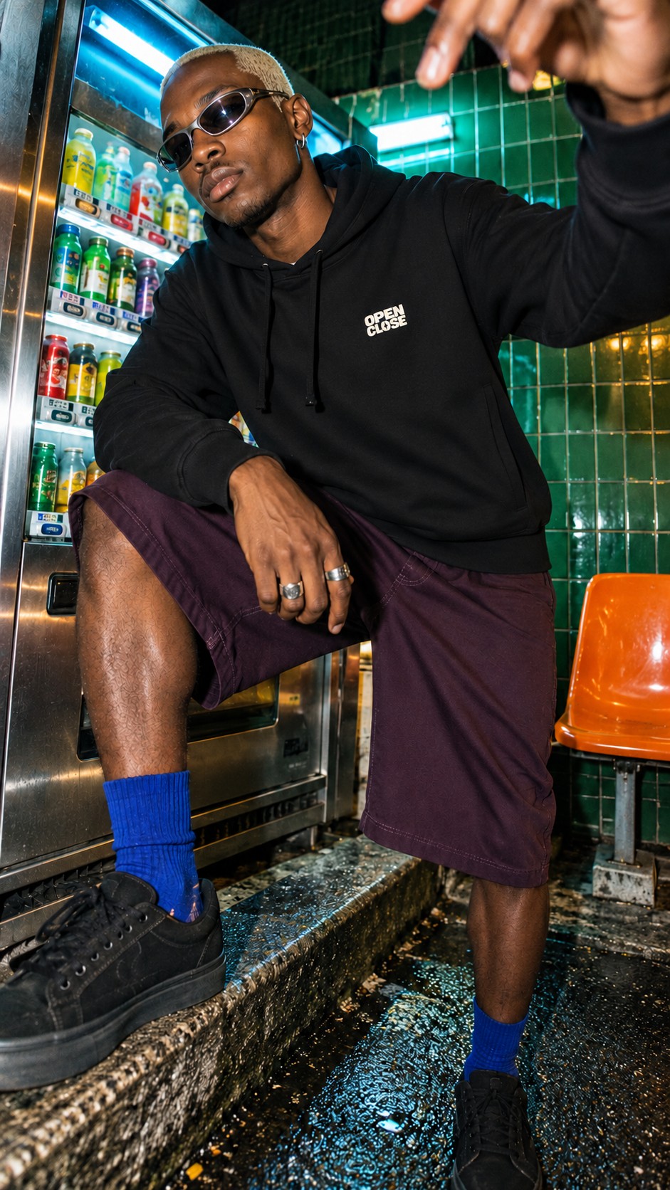 Local Knowledge Side Pocket Hoodie worn by a model, front view, by a drinks fridge