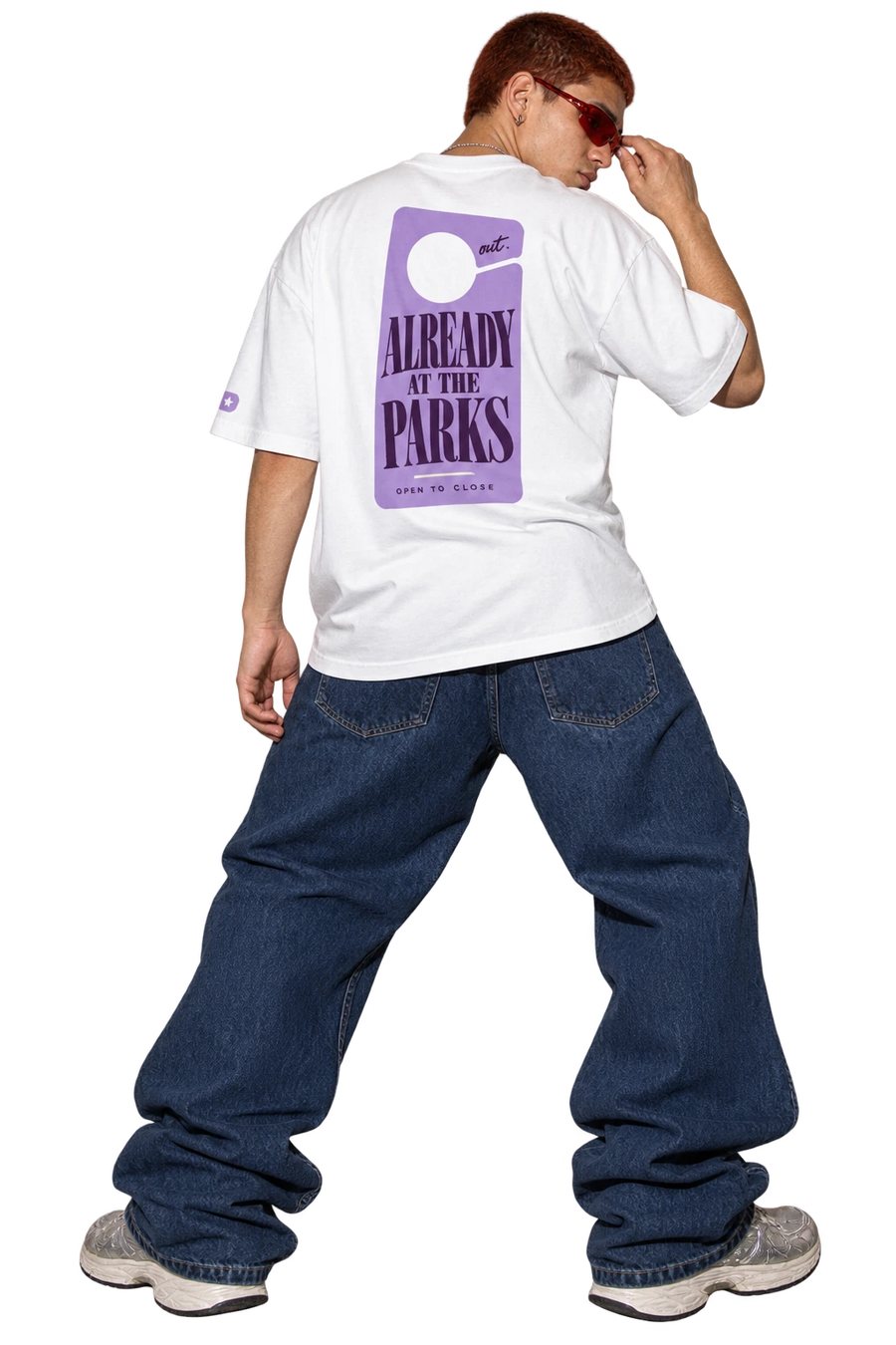 Out Early. Back Late. tee worn by a model, back view, studio