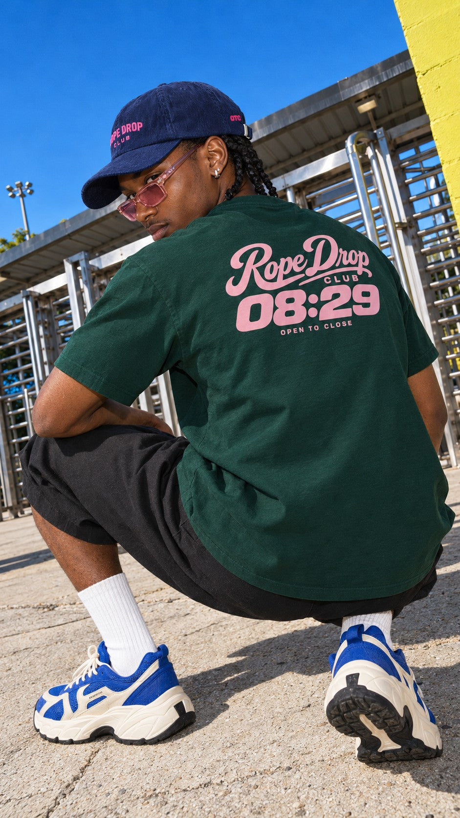 Rope Drop Club tee worn by a model, back view, by the entry gates
