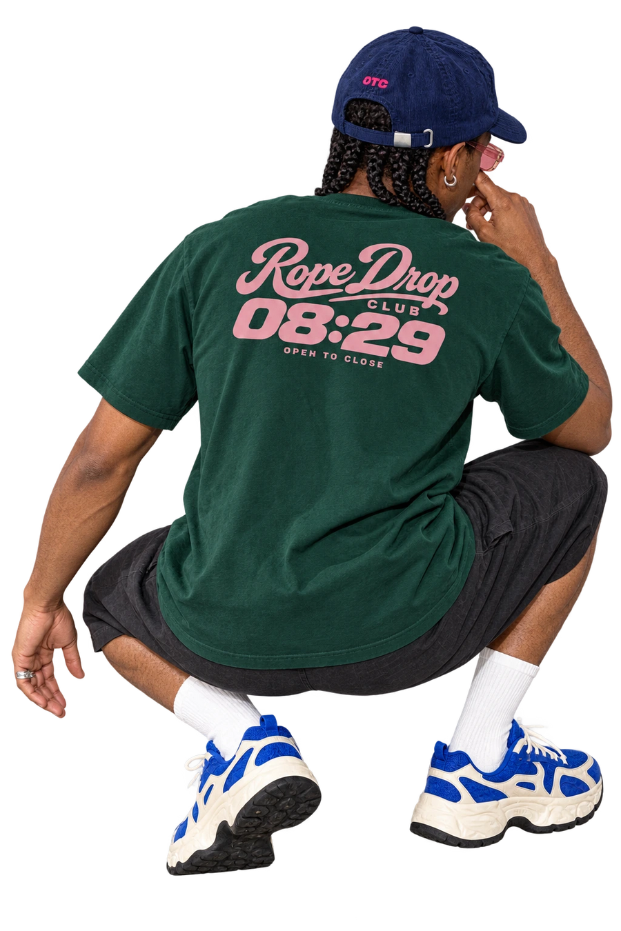 Rope Drop Club tee worn by a model, back view, studio