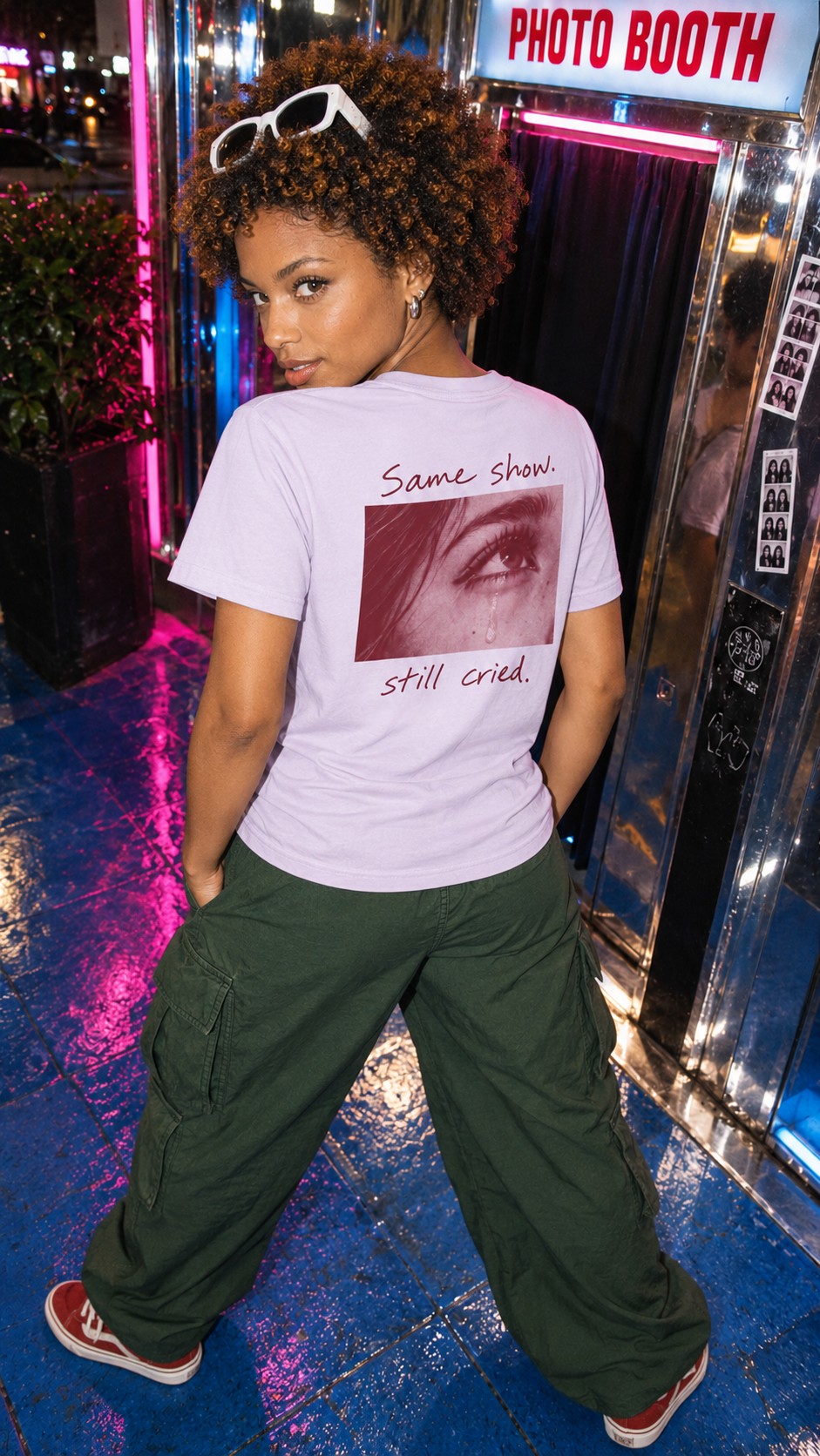 Same Show Tee in Lavender worn by a model, back view, outside a photo booth