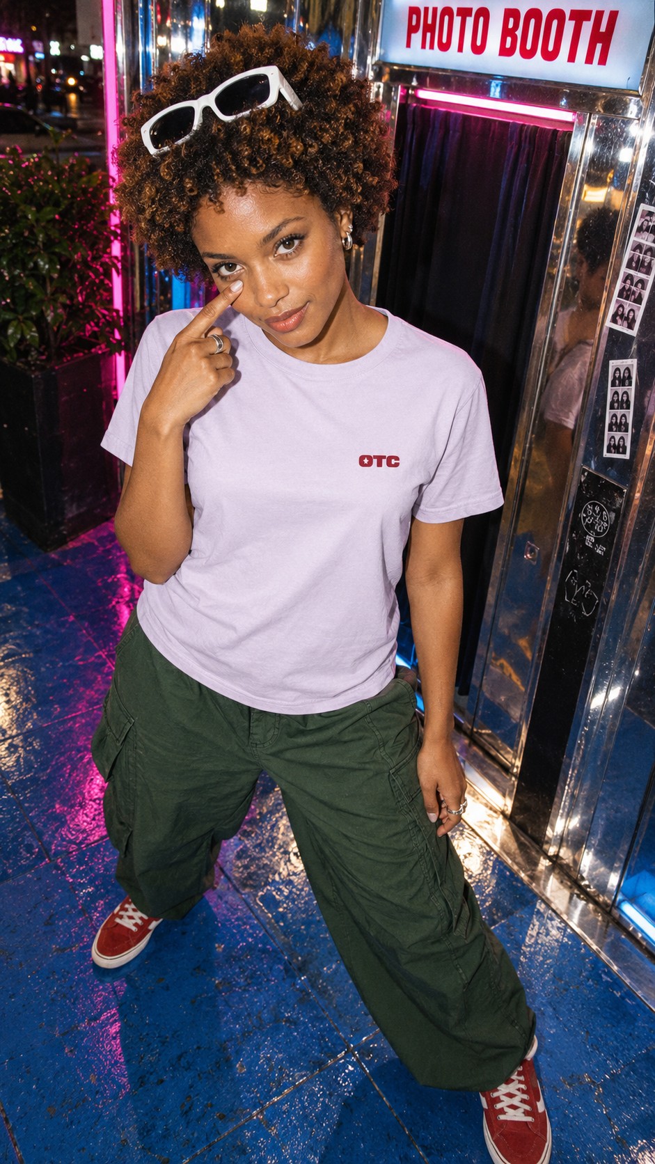 Same Show Tee in Lavender worn by a model, front view, outside a photo booth